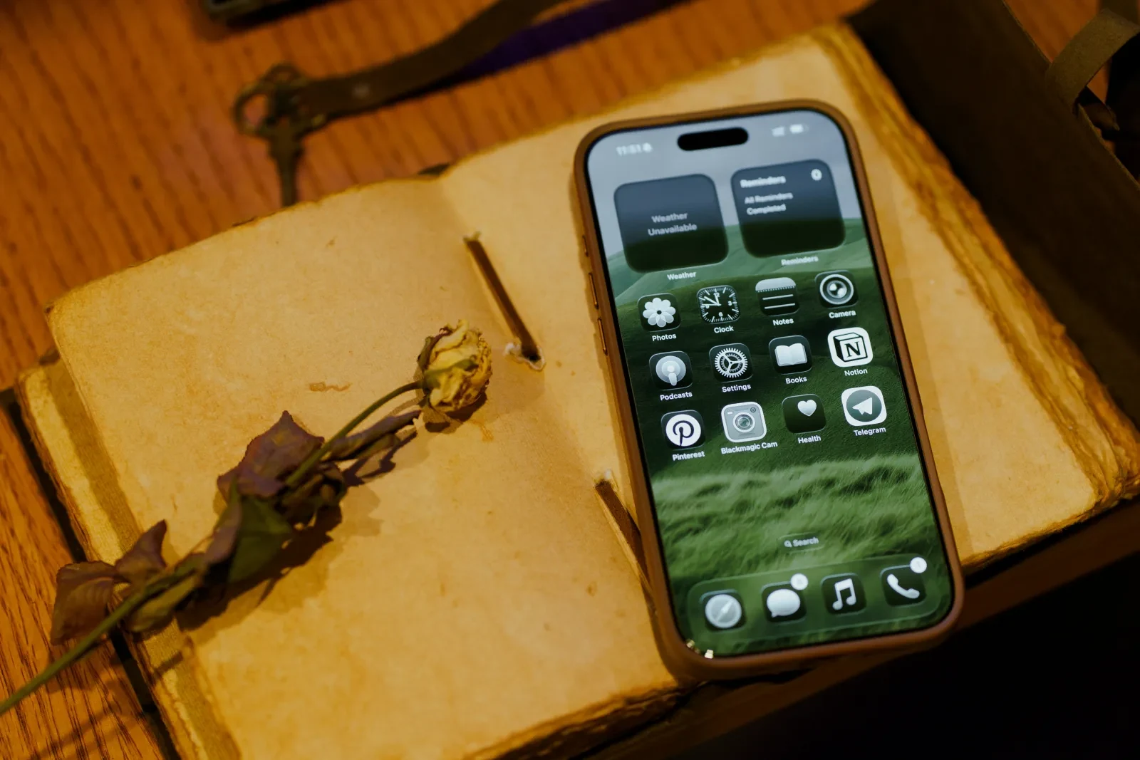 An iPhone resting on the pages of an old handwritten journal: the phone-scan workflow where handwriting meets an AI agent's image pipeline.