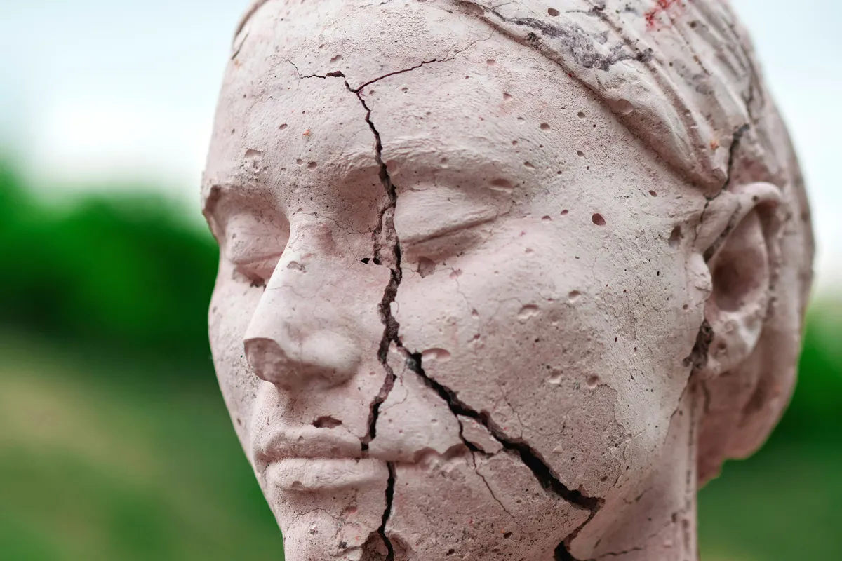 Cracked statue with a serene expression